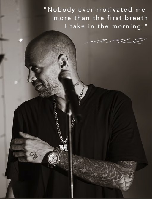 Black-and-white portrait of Marc Marcel with his quote: Nobody ever motivated me more than the first breath I take in the morning